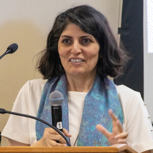 Mehrnaz Ahmadi Joobaneh speaks into a microphone