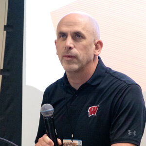 Tyler Schultz speaks into a microphone