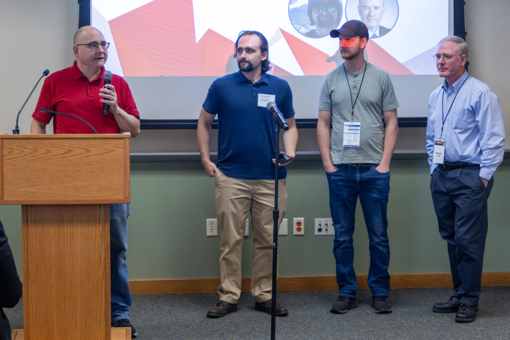 Brad Graham, Chance Homme, Shawn Thiele and Bill Tishler accept their award