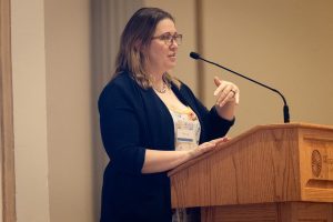 Ella Tschopik speaks at a podium