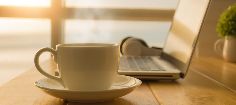 Cup of tea next to laptop
