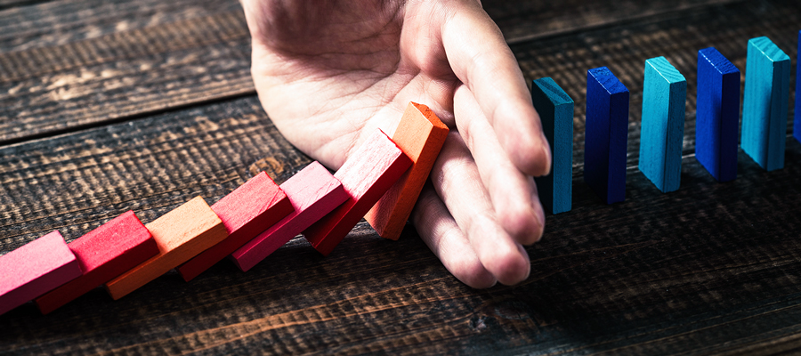 Hand stopping dominoes