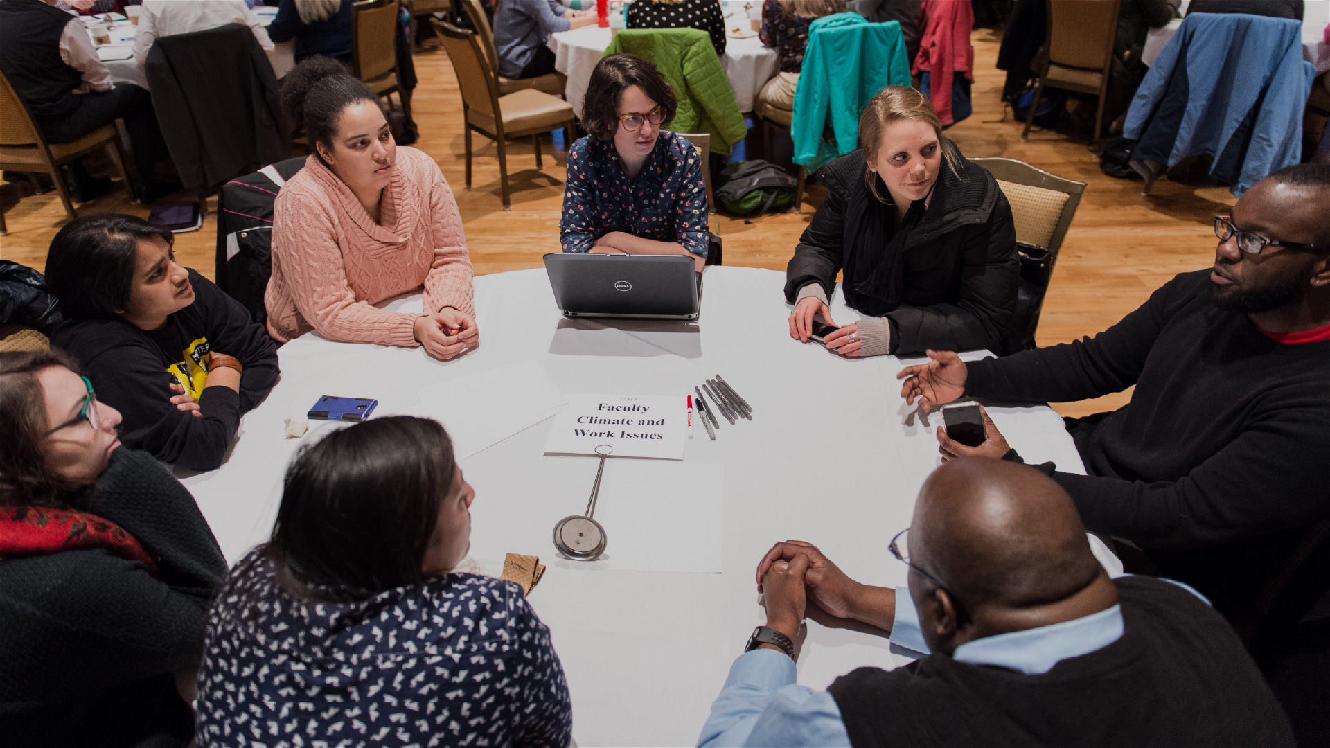 People at a conference table having a discussion