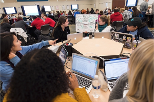 students in an active learning classroom, using computers, whiteboards and other learning aids